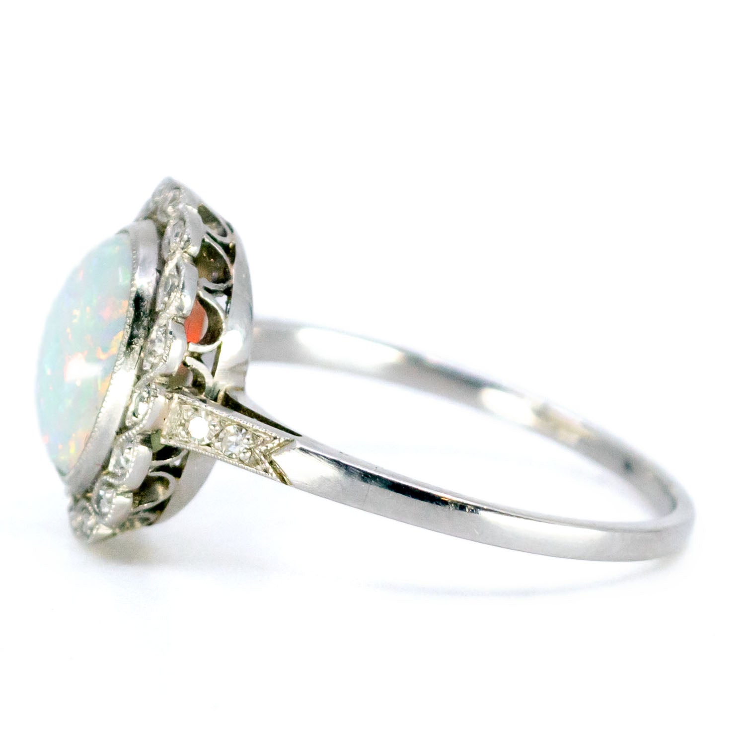 An oval opal and diamond cluster ring in platinum