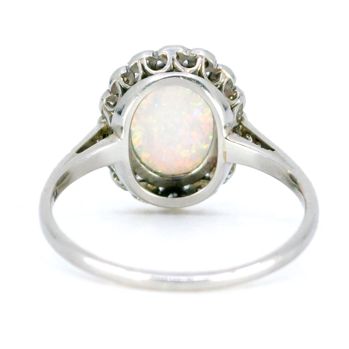 An oval opal and diamond cluster ring in platinum