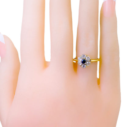 A sapphire and diamond cluster ring in yellow gold, modelled on a hand