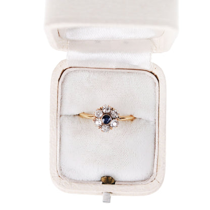 A sapphire and diamond cluster ring in yellow gold, in a ring box