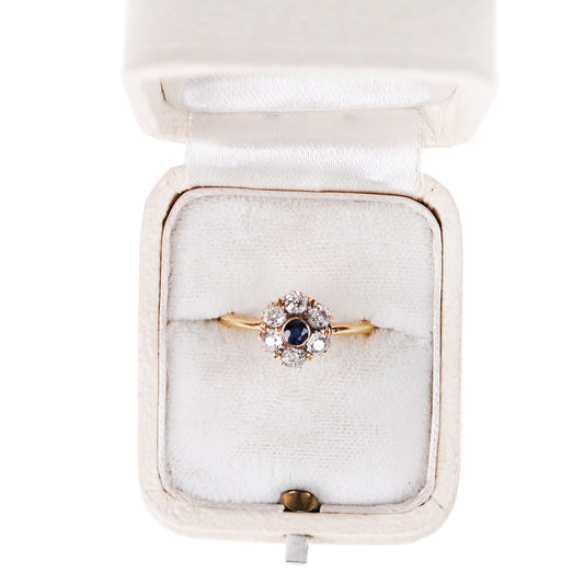 A sapphire and diamond cluster ring in yellow gold, in a ring box