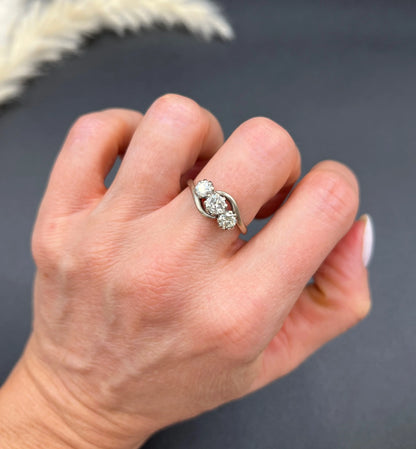A three stone diamond crossover ring, modelled on a hand