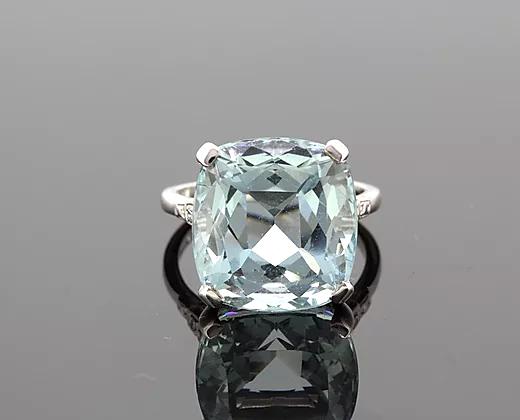 Cushion-Cut 15.17ct Aquamarine and Diamond Ring in Platinum; featuring a 15.17 carat cushion-cut aquamarine, four-claw set, with diamond set shoulders.