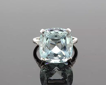Cushion-Cut 15.17ct Aquamarine and Diamond Ring in Platinum; featuring a 15.17 carat cushion-cut aquamarine, four-claw set, with diamond set shoulders.