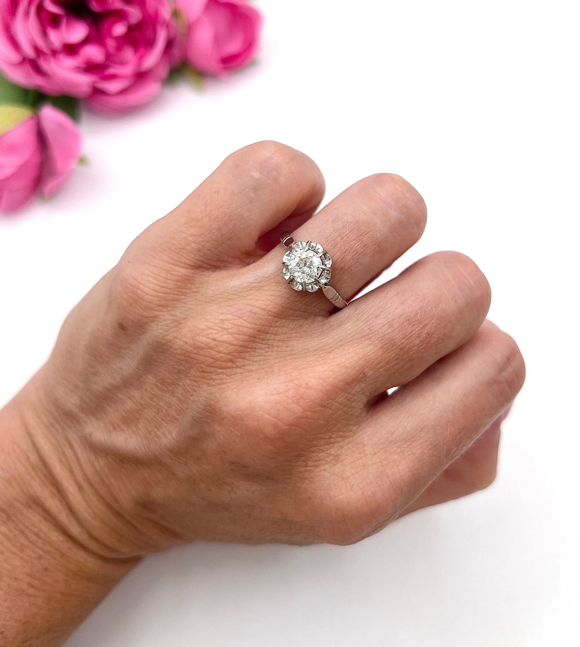 A solitaire diamond ring in platinum, modelled on a hand