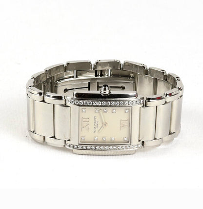 Patek Philippe Twenty-4 Stainless Steel 4910 Ladies 25mm Diamond Dial Quartz Rectangular Watch, white dial, diamond dot hour markers and Roman numerals, diamonds set to each side of the dial, blue cabochon gem set crown, Patek stainless steel bracelet with a hidden double deployment clasp.