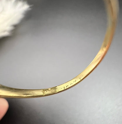 Close-up of a faded stamp inside a yellow gold ring shank