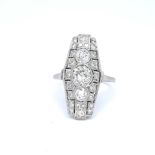 Art Deco Diamond and Platinum Three Stone Cluster Plaque Ring; featuring three brilliant cut diamonds in vertical formation surrounded by smaller circular diamonds, set in a pierced platinum mount with millegrain edging
