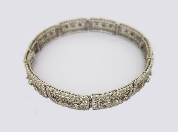 Art Deco Diamond and Platinum Filigree Panel Bracelet; Art Deco diamond filigree panel bracelet set with brilliant cut diamonds. Tests as platinum.