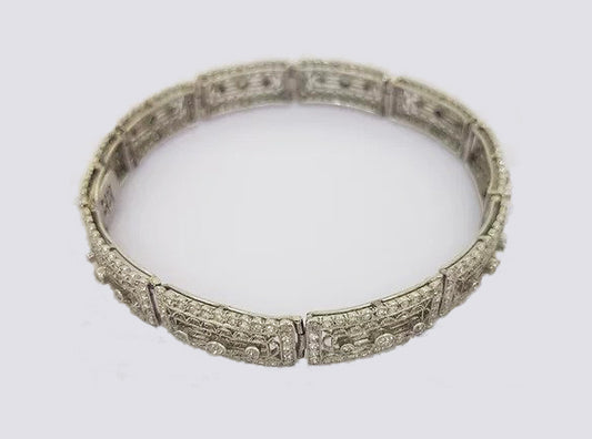 Art Deco Diamond and Platinum Filigree Panel Bracelet; Art Deco diamond filigree panel bracelet set with brilliant cut diamonds. Tests as platinum.