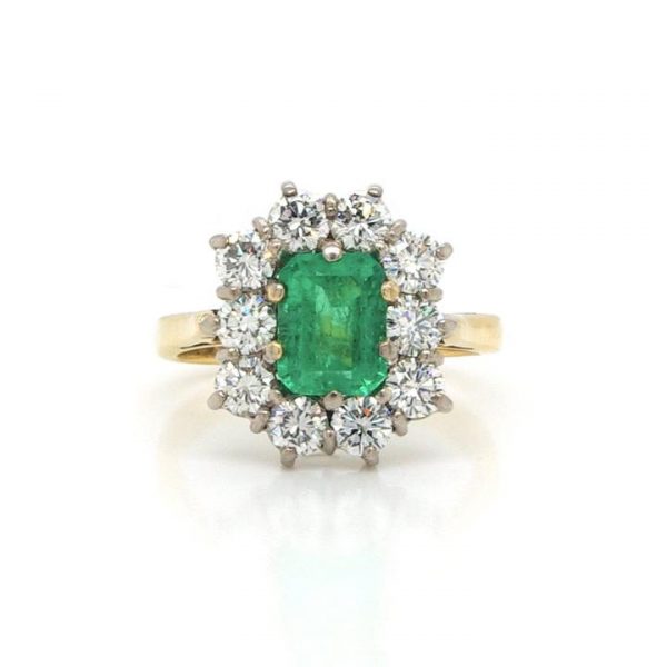 Emerald Cut 1.20ct Emerald and Diamond Cluster Ring, crafted from 18ct yellow gold. Emerald: 1.20 carats. Diamonds (10): 1.30 carat total. Ring size: M