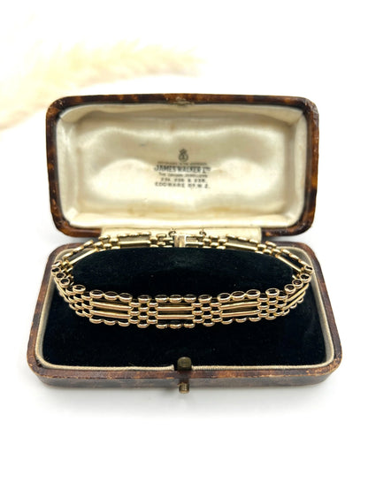 A yellow gold gate bracelet, in an antique box