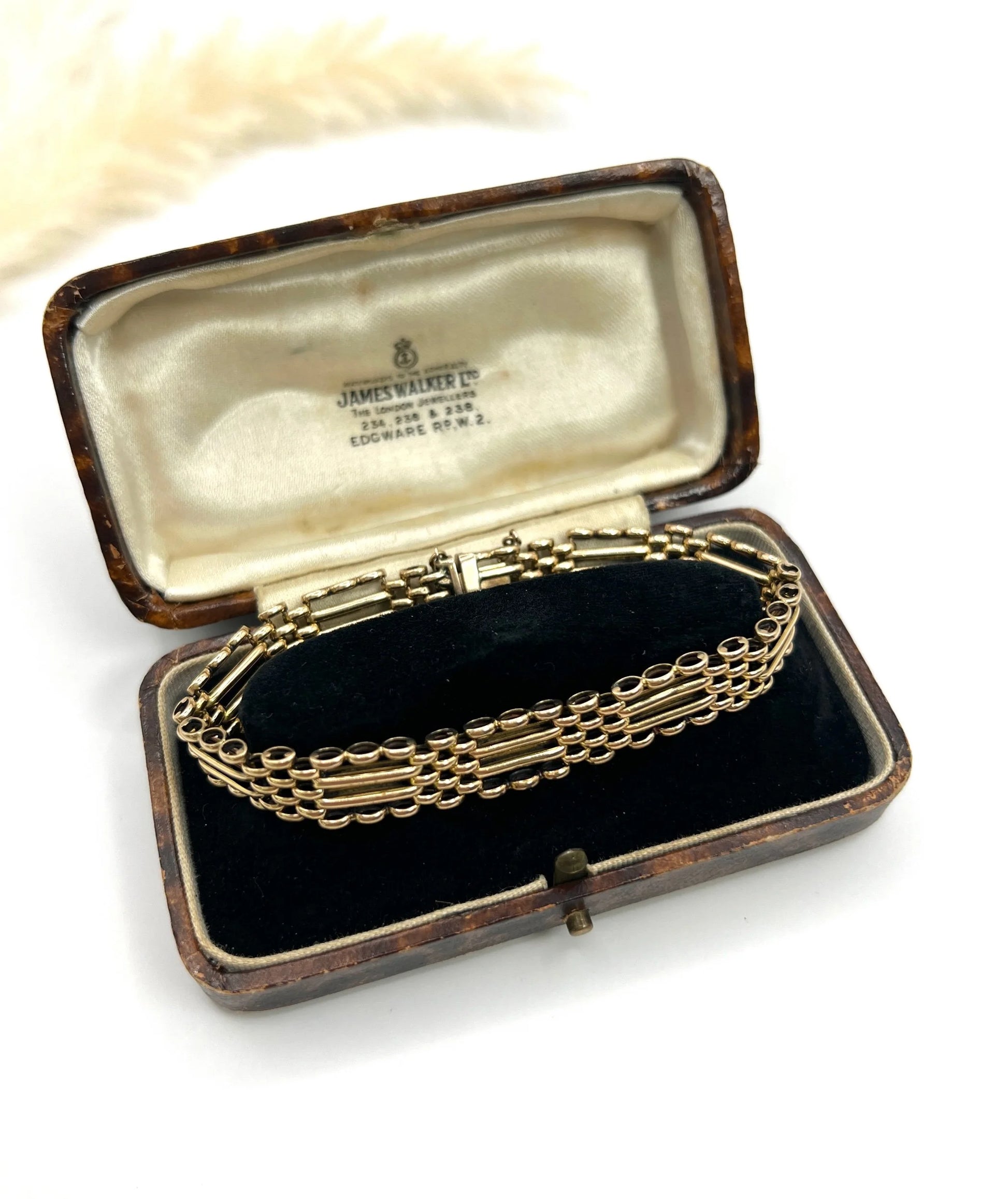 A yellow gold gate bracelet, in an antique box