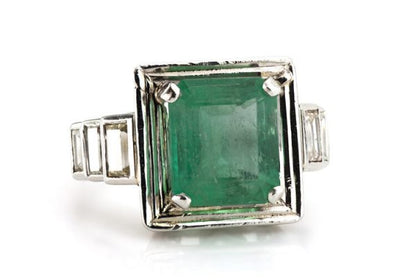 4.20ct Natural Colombian Emerald and Baguette Diamond Ring; natural 4.20 carat octagonal-cut Colombian emerald flanked by 0.70cts baguette cut diamond set shoulders, with GCS Certificate