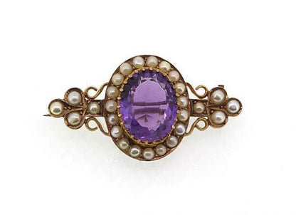 Antique Victorian Amethyst and Pearl Cluster Brooch; A pretty brooch set with an oval-faceted amethyst and split pearls. Mounted in high carat gold.