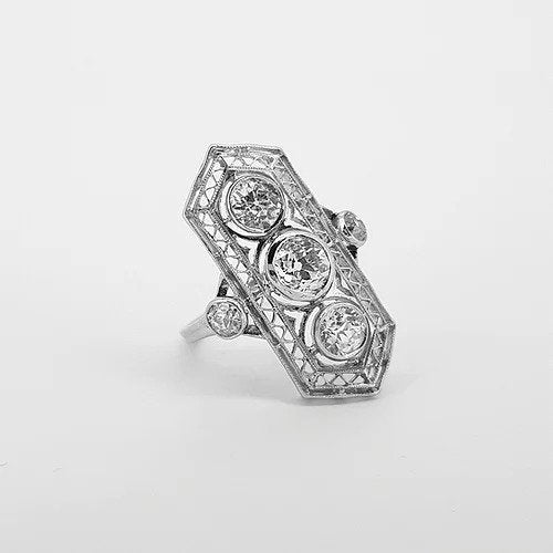 Belle Epoque Three Stone Diamond Plaque Ring; three central diamonds within an openwork platinum mount, diamond set shoulders, 1.50 carats