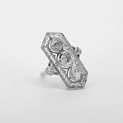 Belle Epoque Three Stone Diamond Plaque Ring; three central diamonds within an openwork platinum mount, diamond set shoulders, 1.50 carats