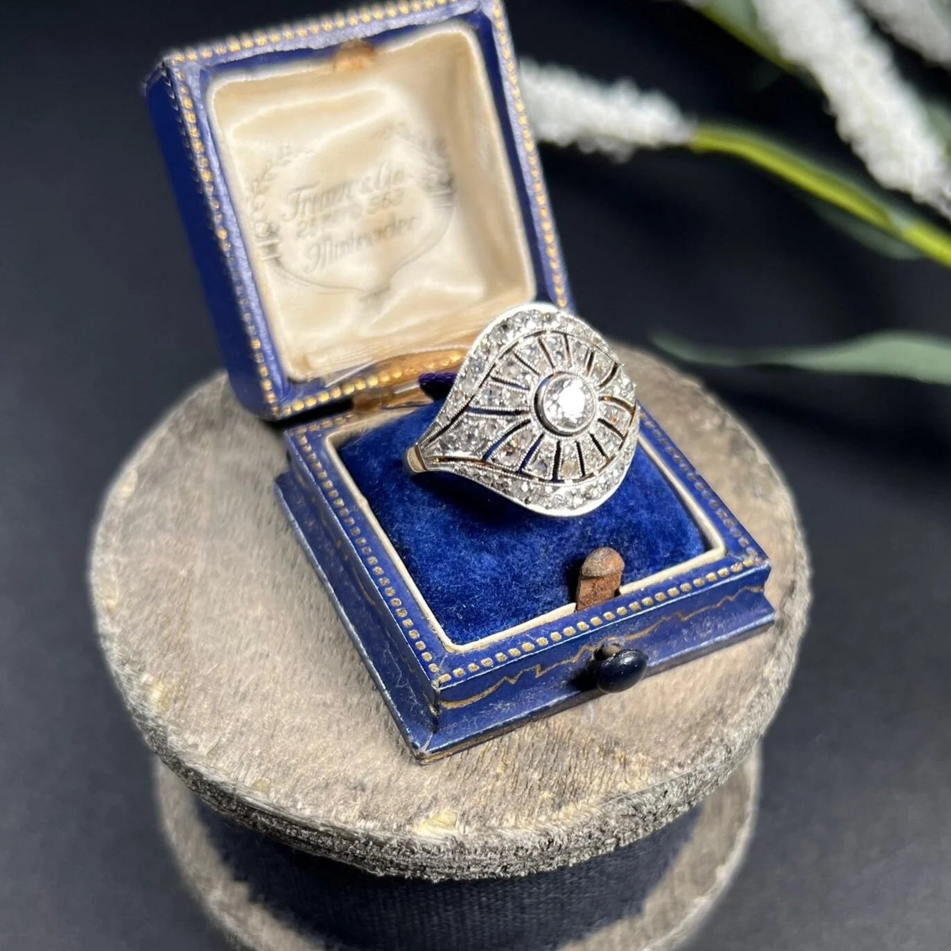 A diamond cocktail ring in yellow and white metal, in an antique ring box