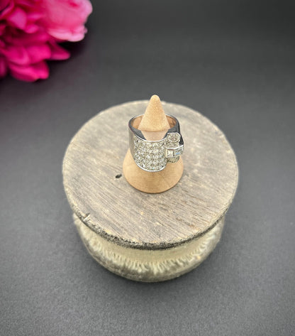 A round diamond tank style cocktail ring in platinum, on a ring cone