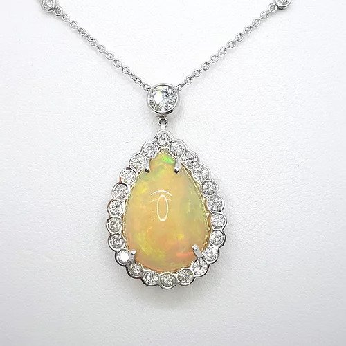 Opal and Diamond Pear Cluster Pendant Necklace; 10.00 carat pear-shaped cabochon-cut opal surrounded by 1.80cts diamonds, on a diamond set chain, in 18ct white gold