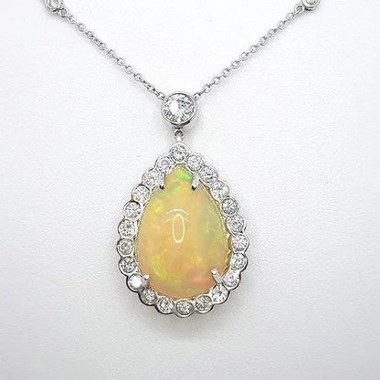 Opal and Diamond Pear Cluster Pendant Necklace; 10.00 carat pear-shaped cabochon-cut opal surrounded by 1.80cts diamonds, on a diamond set chain, in 18ct white gold
