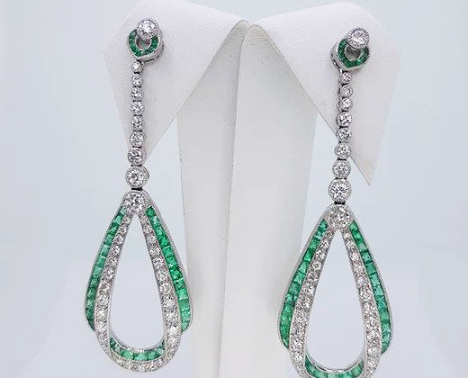 Pair of Contemporary Emerald, Diamond and Platinum Drop Earrings; set with calibre-cut emeralds and round brilliant-cut diamonds, in platinum