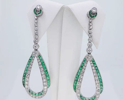 Pair of Contemporary Emerald, Diamond and Platinum Drop Earrings; set with calibre-cut emeralds and round brilliant-cut diamonds, in platinum