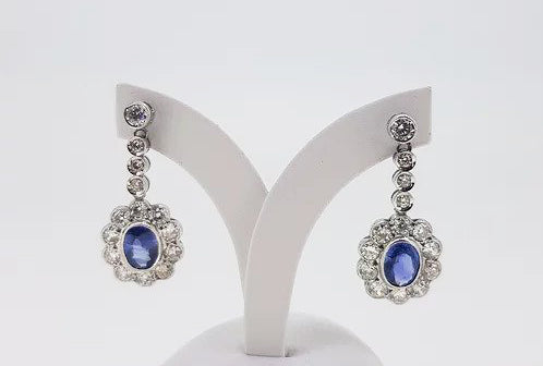 Sapphire and Diamond Oval Floral Cluster Drop Earrings; 2.50cts oval sapphires surrounded by 2.76cts diamonds, diamond set drops, 18ct gold