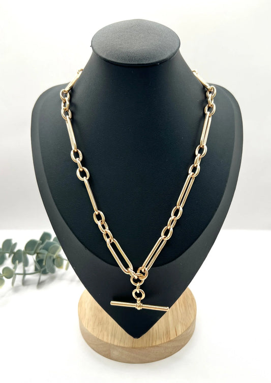 A rose gold trombone and fetter link Albert chain, on a black jewellery bust