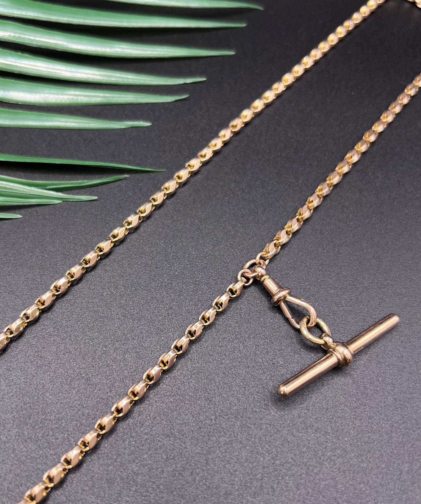 A rose gold tulip link chain necklace with a dog clip clasp and T-bar