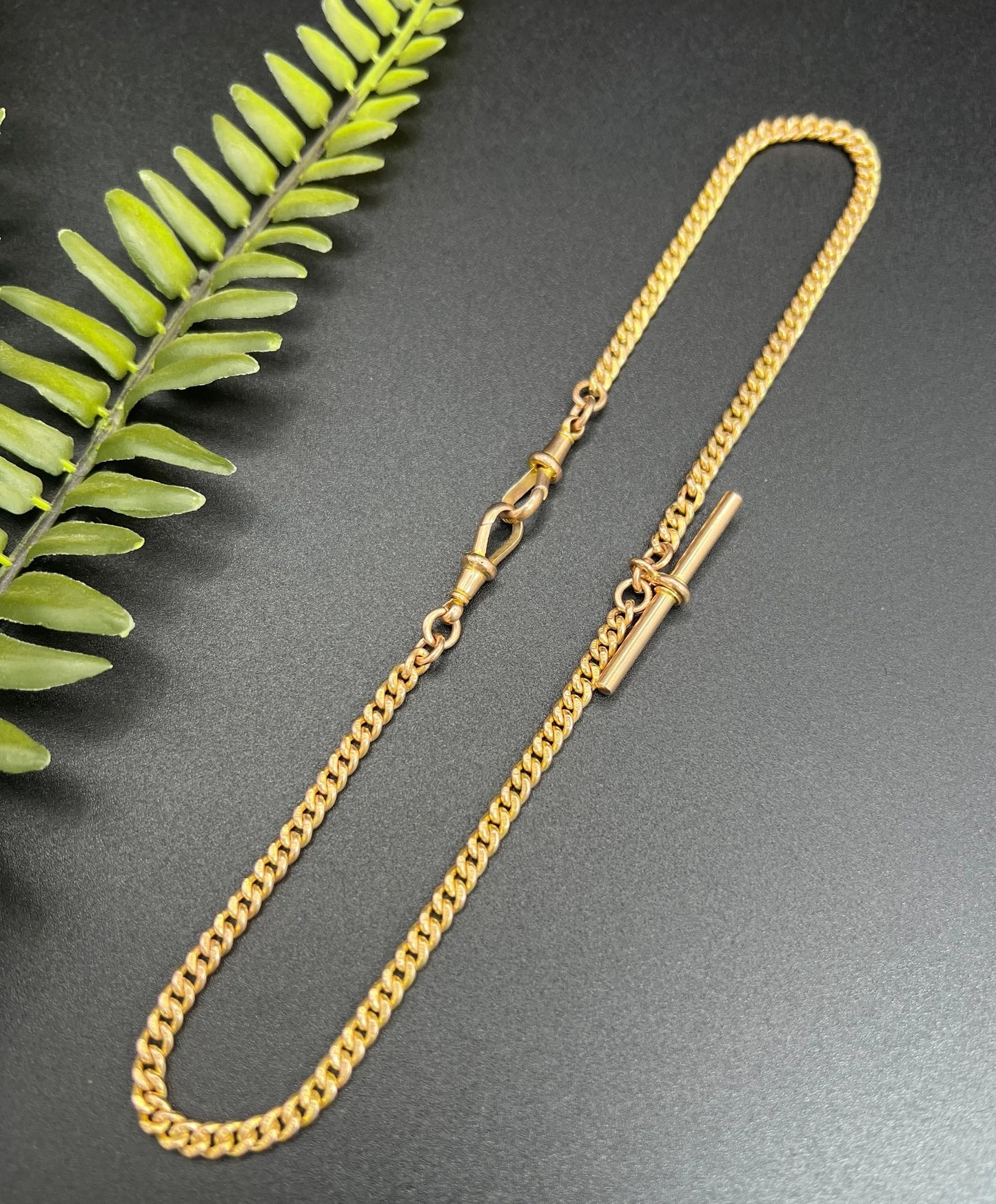 A yellow gold curb link Albert watch chain