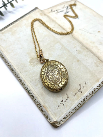 Early Victorian 15 Carat Yellow Gold Floral Engraved Oval Shaped Locket, Circa 1860