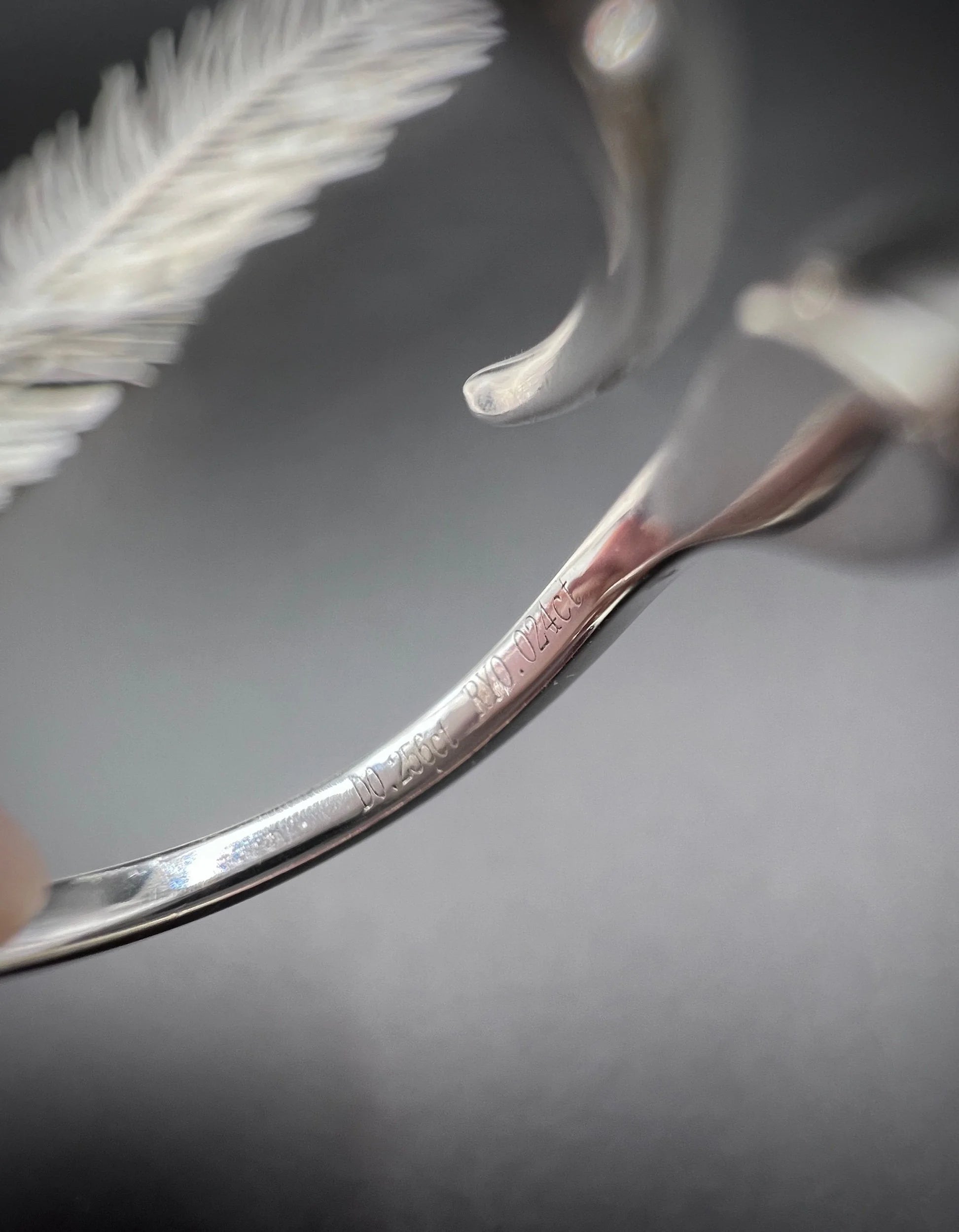 Close-up of stamps inside a white gold ring shank