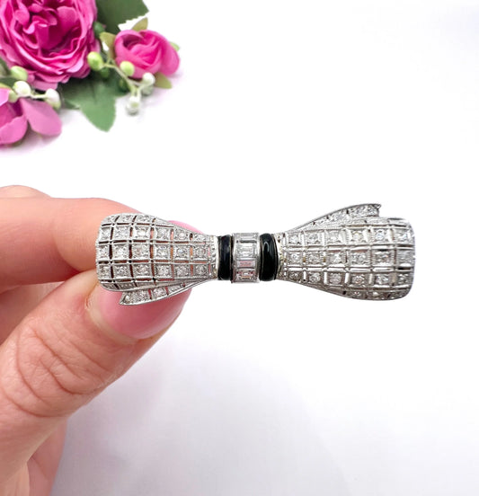 Art Deco 14 Carat White Gold Onyx and Diamond Bow Brooch, Circa 1920