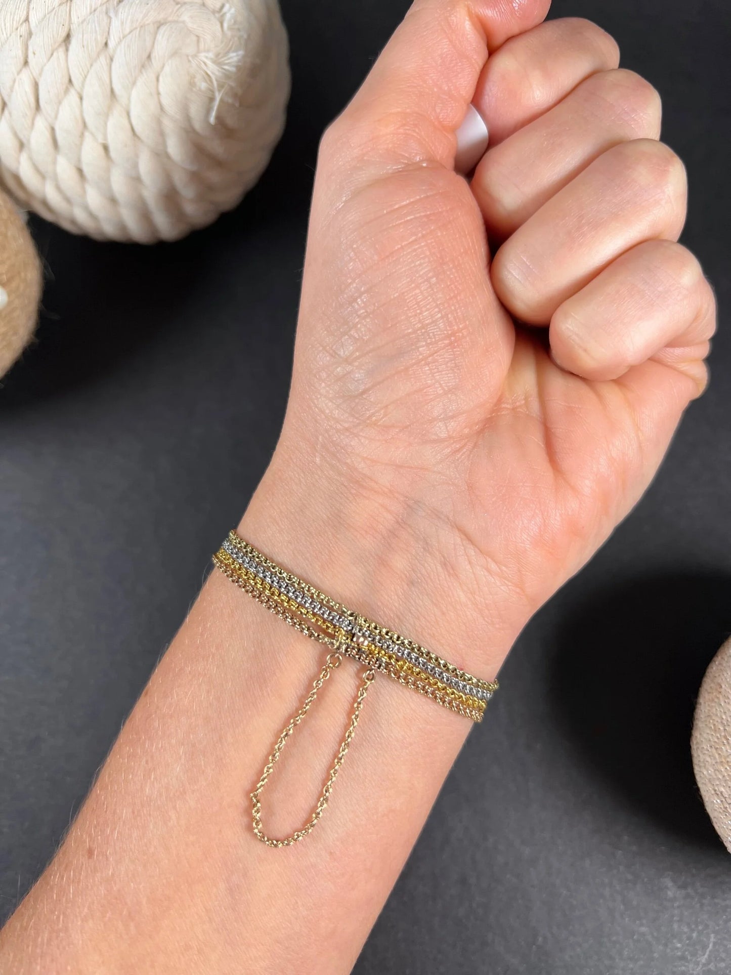 A cabochon garnet bracelet with three colour gold chains, modelled on a wrist