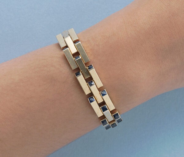 Cartier Gold Retro Bracelet Set With Sapphires; industrial design tank link gold bracelet set with thirty-one French square cut sapphires, Signed and numbered, Circa 1940