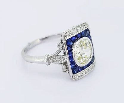 Vintage 1.25ct Old Cut Diamond and Sapphire Panel Ring; 1.25ct old-cut diamond, surrounded by calibre-cut sapphires and brilliant-cut diamonds, 18ct gold