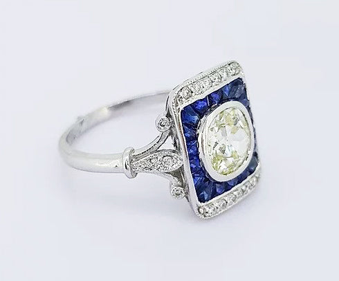 Vintage 1.25ct Old Cut Diamond and Sapphire Panel Ring; 1.25ct old-cut diamond, surrounded by calibre-cut sapphires and brilliant-cut diamonds, 18ct gold