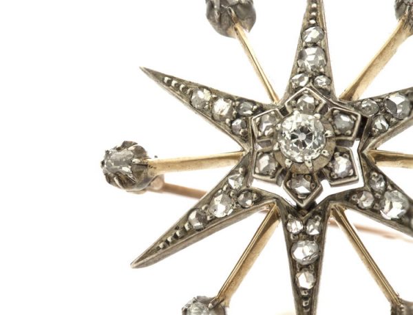 Antique Victorian Old Cut Diamond Star Brooch; set with rose cut and old European cut diamonds, 0.88 carat total, set in silver and 15ct gold