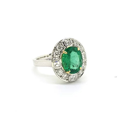 Emerald and Diamond Oval Cluster Ring; featuring a central 2.29 carat oval faceted emerald surrounded by 0.90cts asscher and brilliant-cut diamonds, in 18ct gold