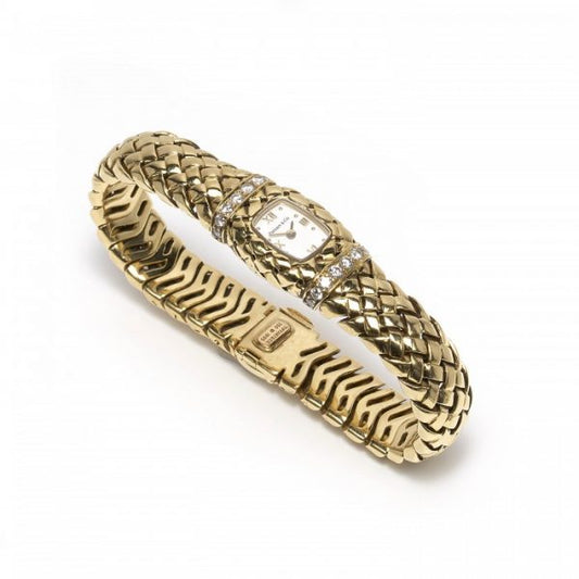 Tiffany and Co Vannerie Diamond and 18ct Yellow Gold Ladies Wristwatch, cushion-shaped white dial with gold Roman numerals at 12, 3, 6 and 9, case set with two rows of round brilliant-cut diamonds, above and below the dial, on a lattice design bracelet, all mounted in 18ct yellow gold, with a quartz movement, clasp is stamped Tiffany & Co., 750, 1995