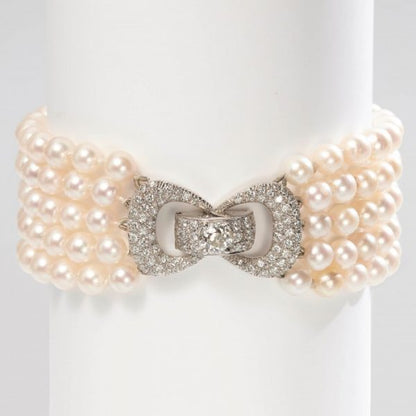 Vintage Five Row Pearl and Diamond Bracelet; five rows of strung white cultured pearls secured by a 2ct diamond-set bow design clasp