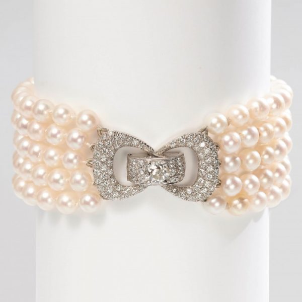 Vintage Five Row Pearl and Diamond Bracelet; five rows of strung white cultured pearls secured by a 2ct diamond-set bow design clasp