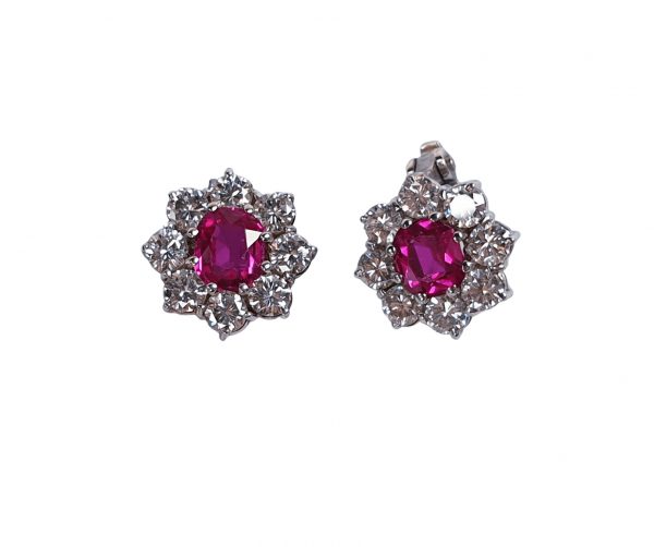 Burmese Ruby and Diamond Flower Cluster Stud Earrings; featuring 1.20cts rubies surrounded by brilliant cut diamonds, in 18ct white gold, Circa 1960s