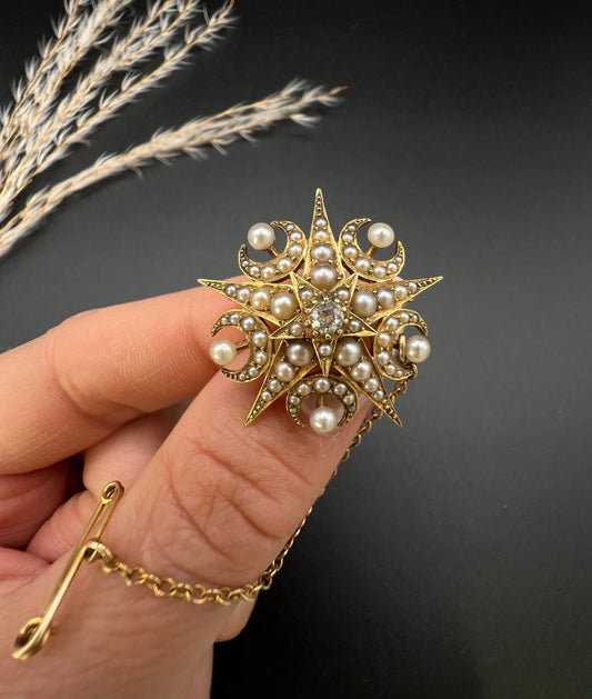 An antique diamond and pearl star and crescent brooch/pendant in yellow gold