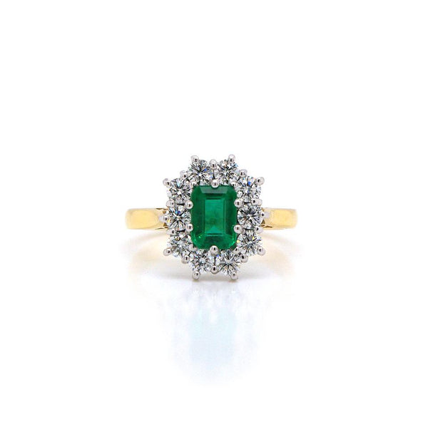 Emerald and diamond cluster ring in yellow and white gold.