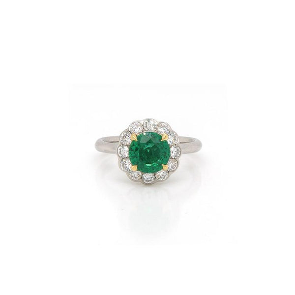 Emerald and diamond cluster ring in platinum.