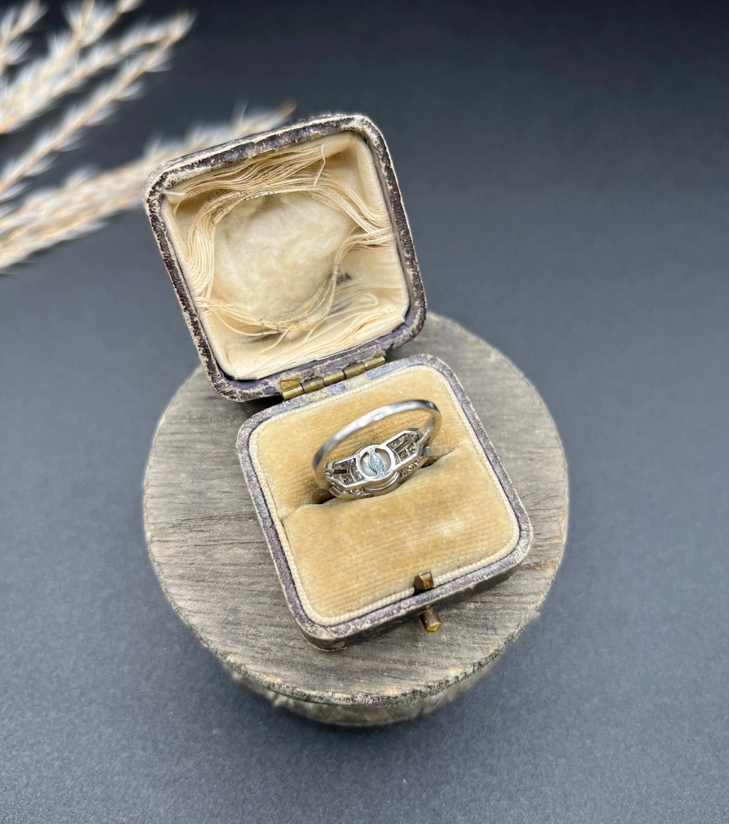 A pearl and diamond ring in platinum, in an antique ring box