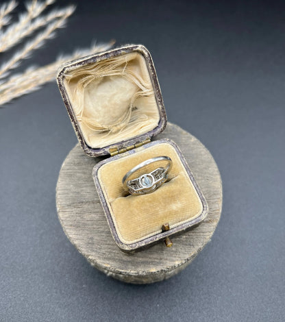 A pearl and diamond ring in platinum, in an antique ring box