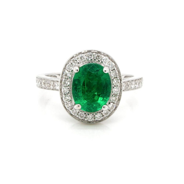 Emerald and diamond cluster ring in white gold.